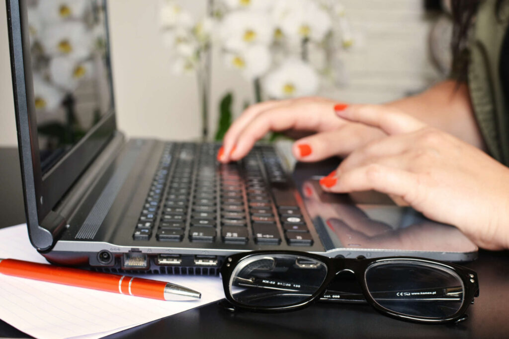 Copywriter writes article on laptop